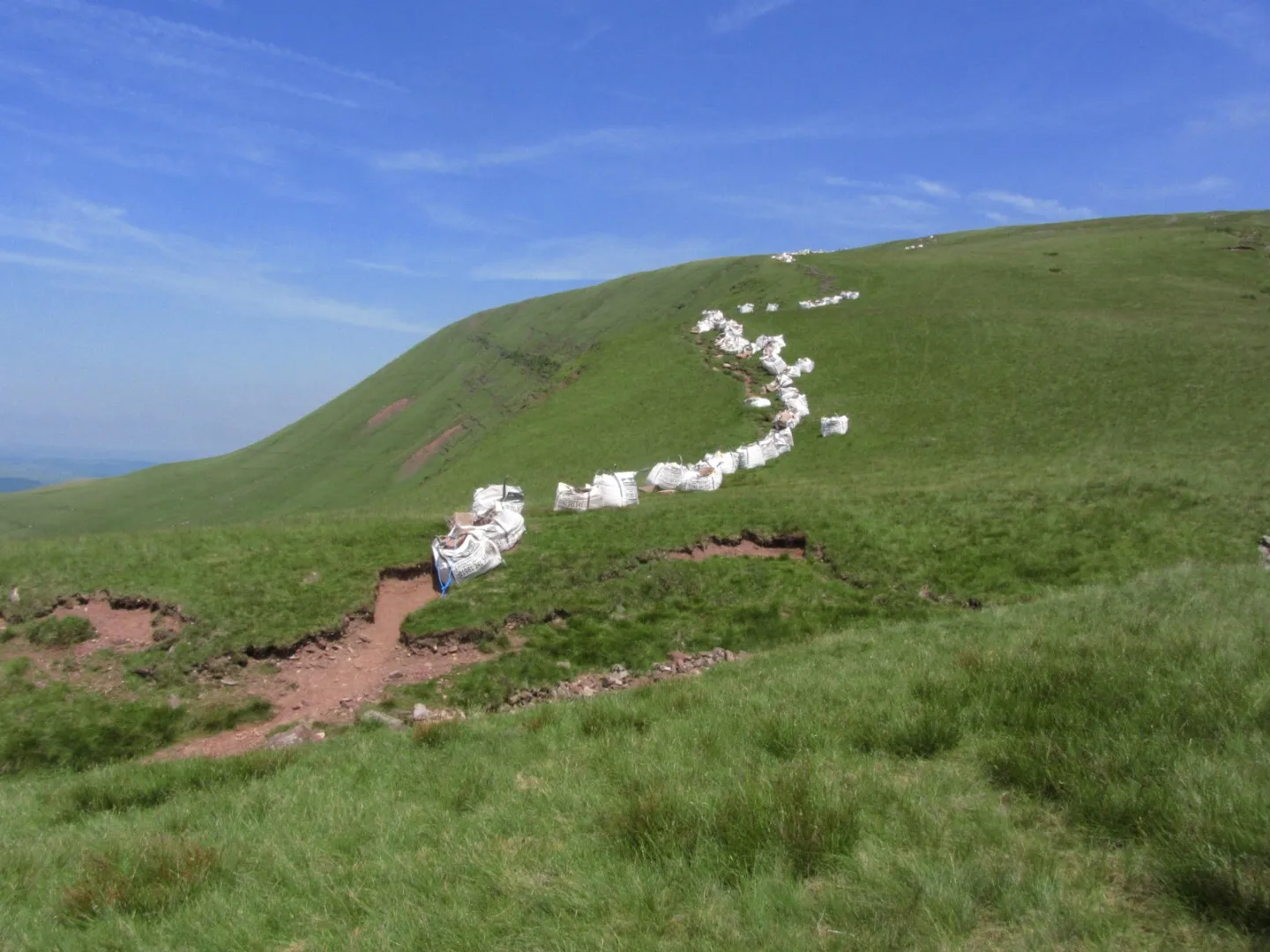13-1048-160713-bags-of-stone-line-the-footpath-up-towards-fan-foel-large
