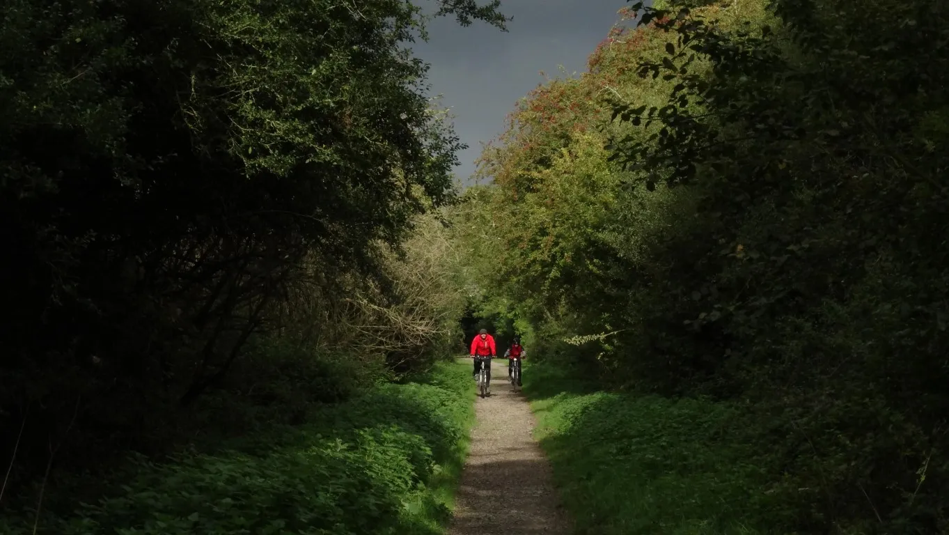 Colourful cyclists on the railway path south of Market Harborough just before it rained.