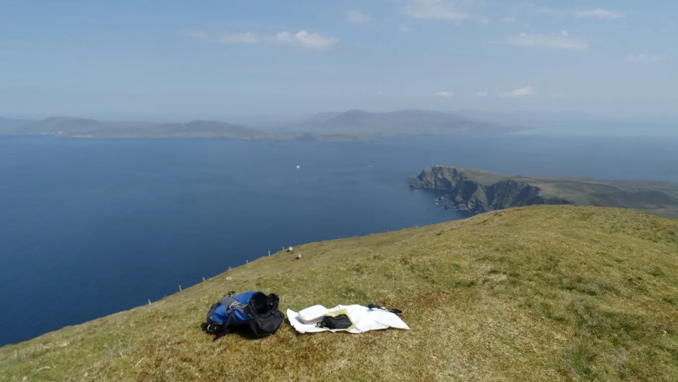Picnic sites don't come any better than this. I'm 450 metres up overlooking Clew Bay on the west coast of Ireland. There is hardly a breath of air on this perfect sunny day. In the distance, sea mist is rolling over a ridge on Achill Island. Pure magic!