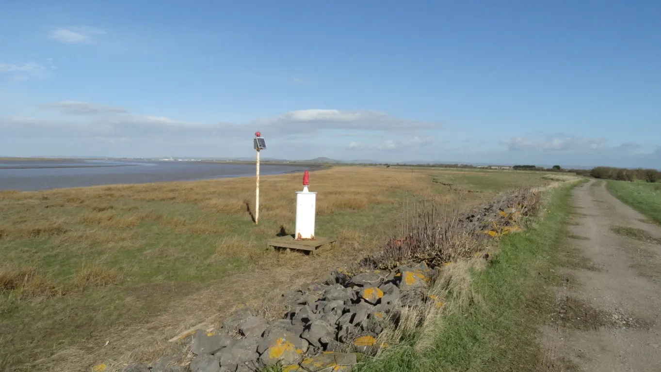 The River Parrett is becoming much wider. These are a couple of navigational aids on the river bank. In the distance is Burnham on Sea and the end of my walk but I will need to trek inland first to cross the River Brue.
