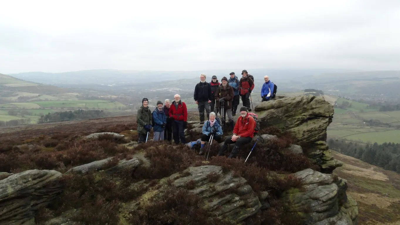 The East Cheshire Ramblers pause on the Wrom Stones above Glossop.
