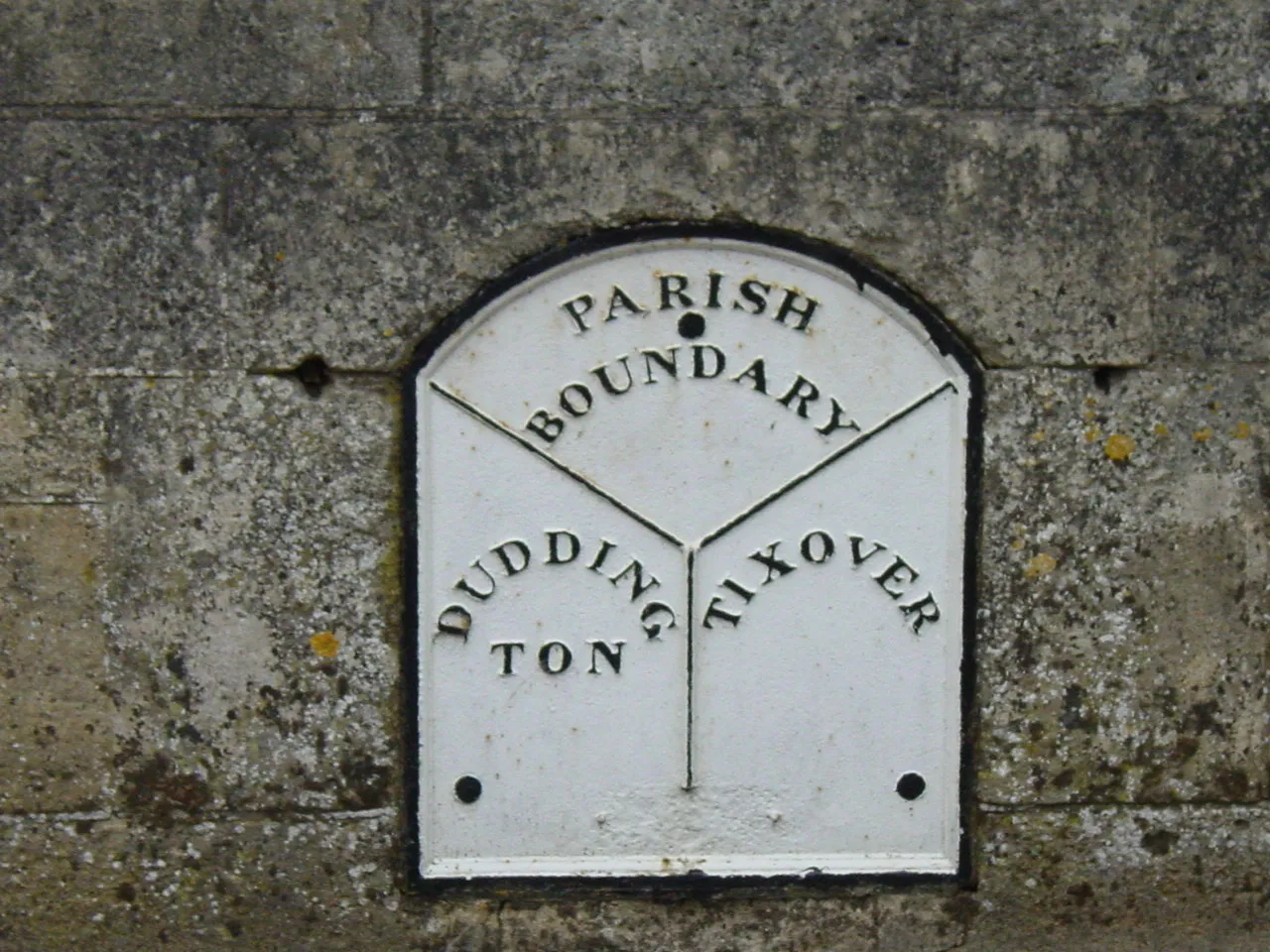 A old parish boundary sign on the border of Duddington, Northamptonshire and Tixover in Rutland (picture from 2005).