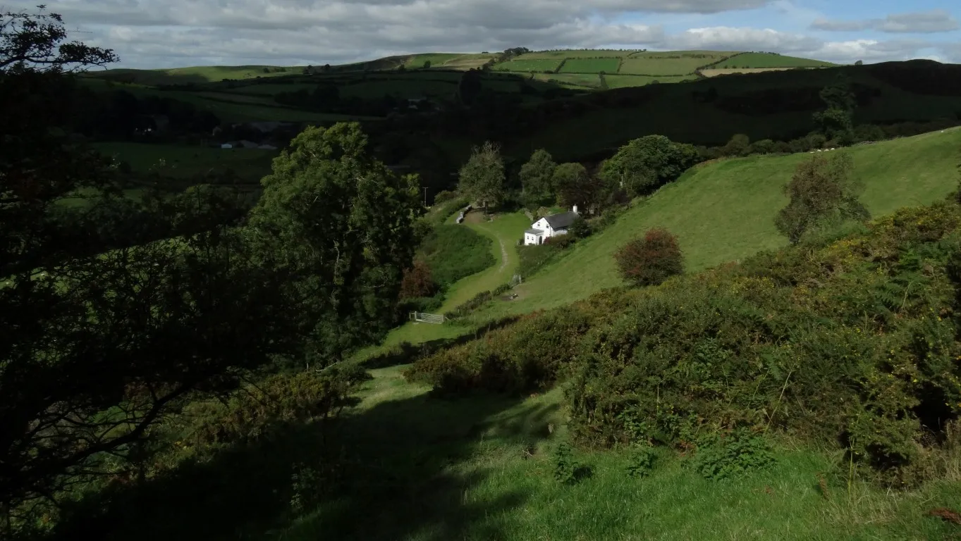Descending along the Offa's Dyke path towards the isolated house at Brynorgan.