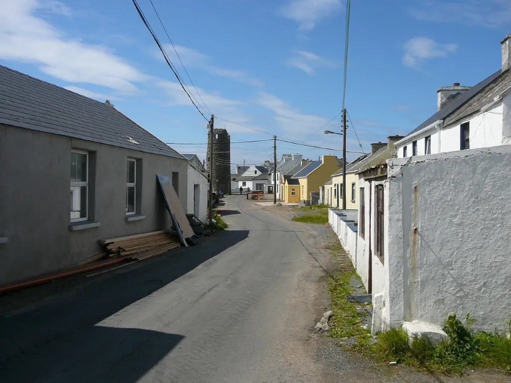 the main village street on tory Island dominated by the round tower of the former
