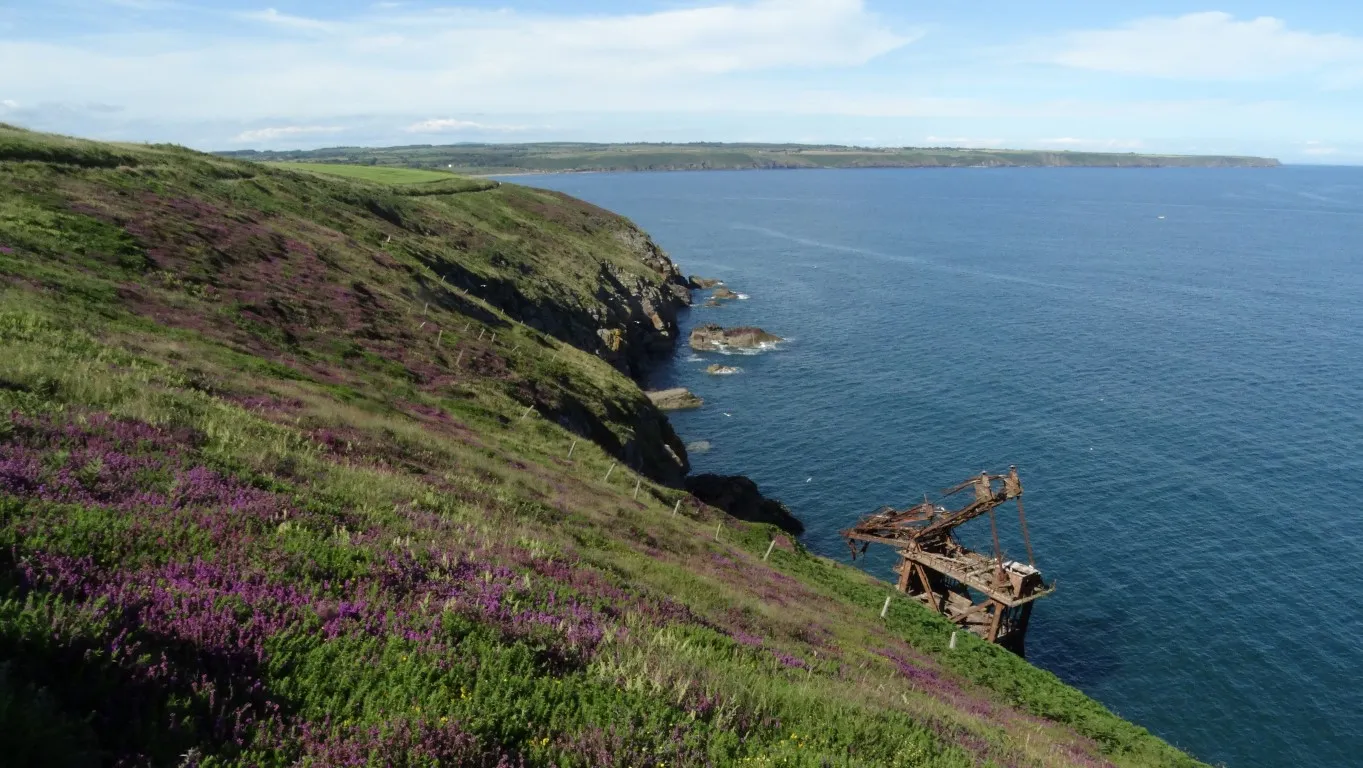 There is a fine coastal walk from Ardmore and the path can be seen on the top left of this picture. The crane Barge 'Samson' has been a attraction along this section of coast since coming aground here in 1987. The crane jib collapsed in 2016.