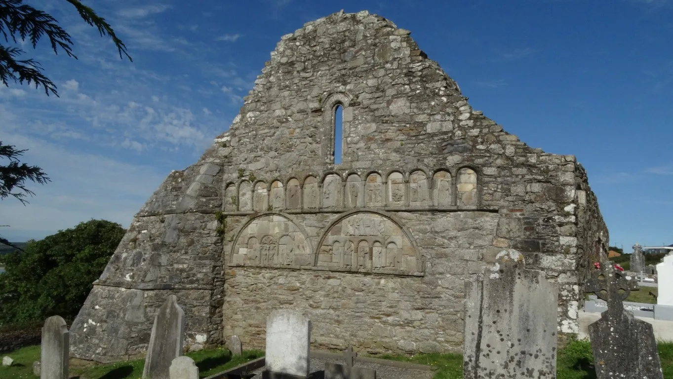 The west wall of the former Ardmore Cathedral depicts scenes in stone from the old and new testaments. The buildings are site on the oldest religious site in Ireland.